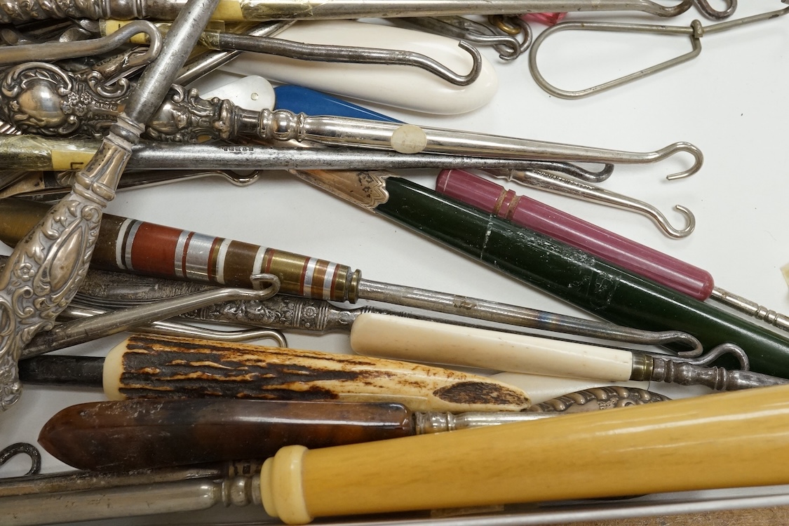 A large collection of Victorian button hooks, with silver, plate, mother of pearl and other handles